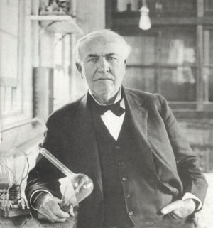 Thomas Alva Edison shown with his invention, the electric incandescent light.
