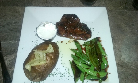 Sirloin Steak with sides of sugar snap peas and baked potato